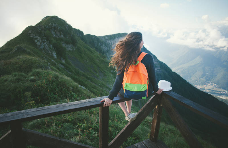 travelling-alone-mountain-top-girl-sit-view