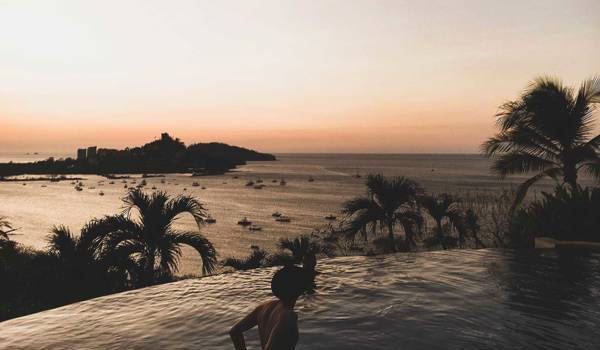 costa-rica-man-in-infinity-pool-at-playa-flamingo