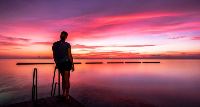 maldives-woman-wathching-horizon-in-sunset