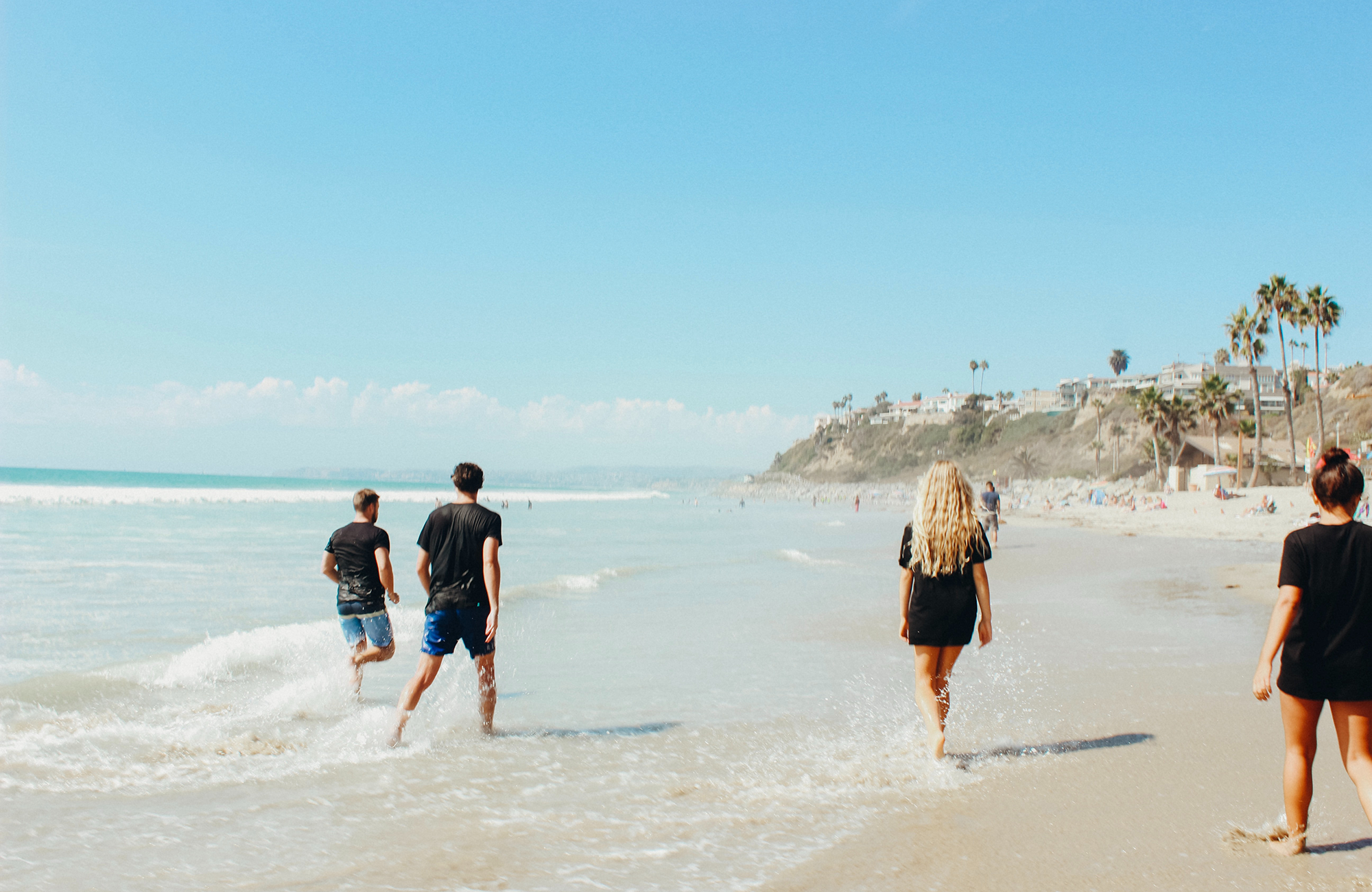 Friends Strolling On The Beach