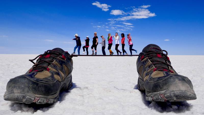 Image of people posing with shoes at the Uyuni salt flats in Bolivia - KILROY