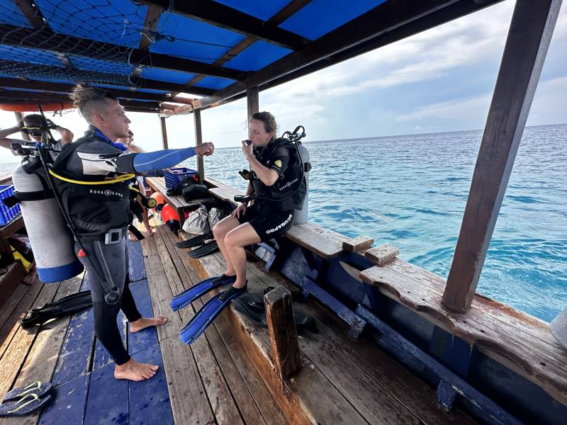 Divers on a boat in the ocean near Gili Trawangan, Indonesia