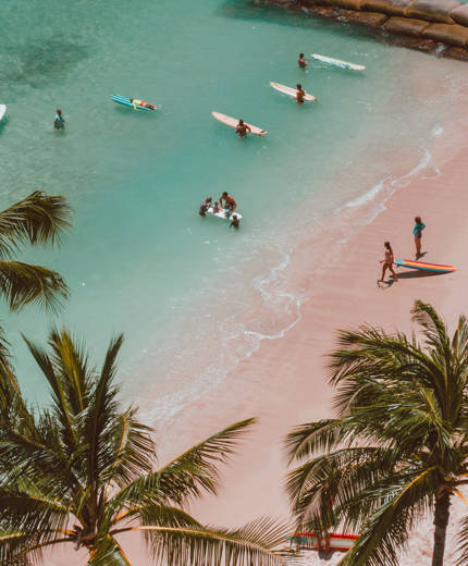 Surfers On A Tropical Beach On Hawaii