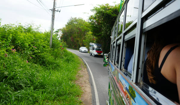 Travellers In A Bus In Thailand In A Green Landscape